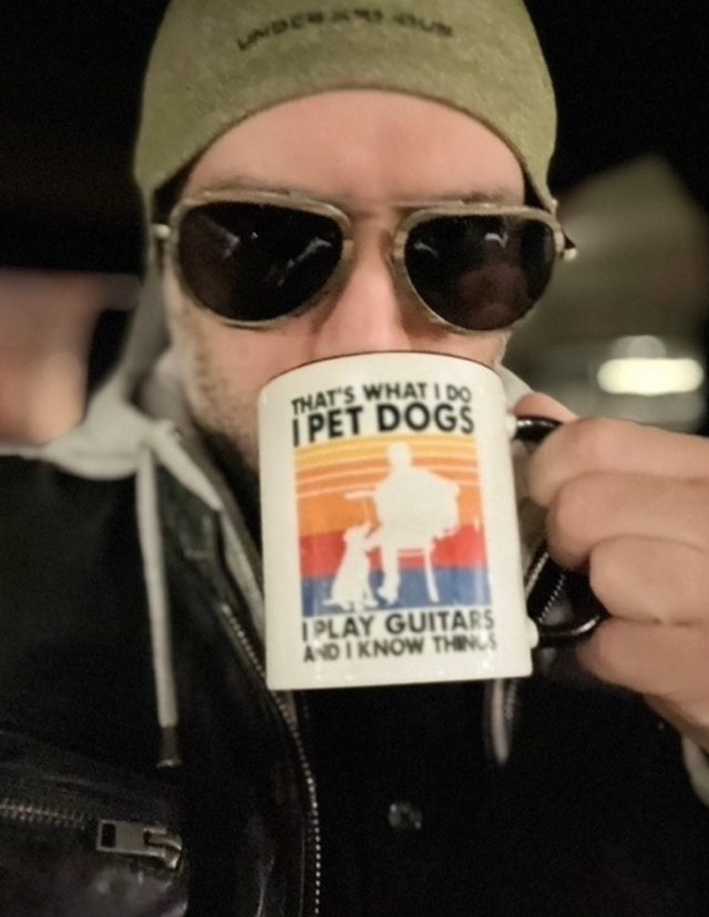 Author Michael K. sipping coffee with sunglasses on